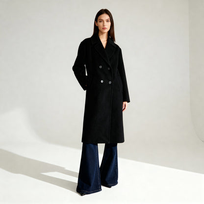 Woman wearing a black coat and blue jeans on a white background